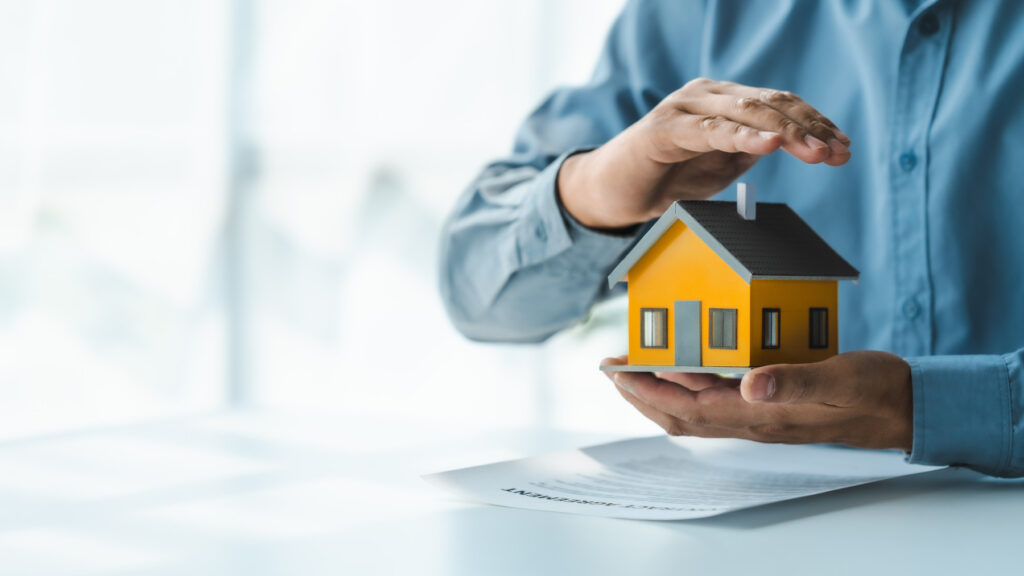 Holding a model house - Loftus Property
